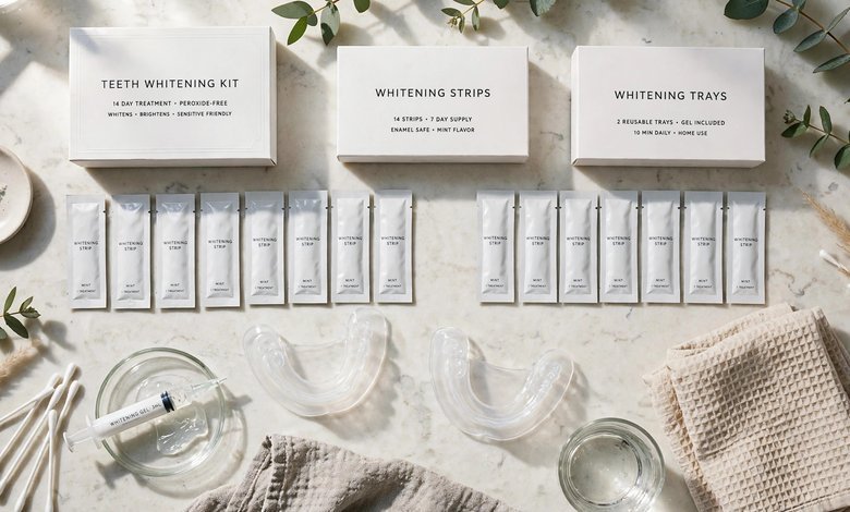 A flat-lay of at-home teeth whitening products, including strips and trays, on a bathroom counter.