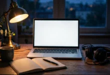 Cozy home office desk at dusk with a laptop, notebook, and headphones, illustrating a guide to the piracy megathread.