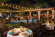 The lit garden patio of Joe T. Garcia's in Fort Worth, Texas, with tables set for a Tex-Mex dinner.