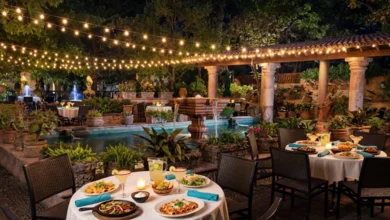 The lit garden patio of Joe T. Garcia's in Fort Worth, Texas, with tables set for a Tex-Mex dinner.