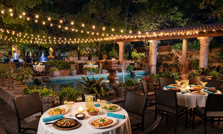 The lit garden patio of Joe T. Garcia's in Fort Worth, Texas, with tables set for a Tex-Mex dinner.